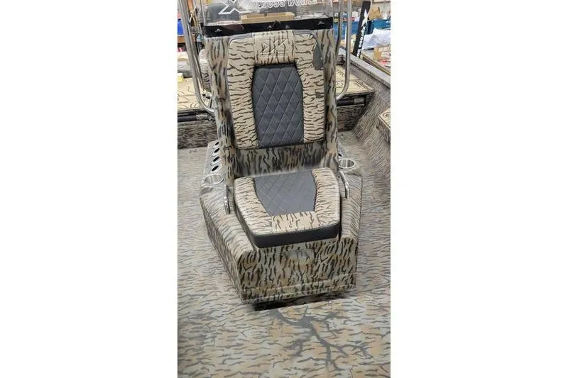 Slide: The Image of 2026 Xpress H20B Bay boat interior with open storage compartments and SeaDek flooring. - 12