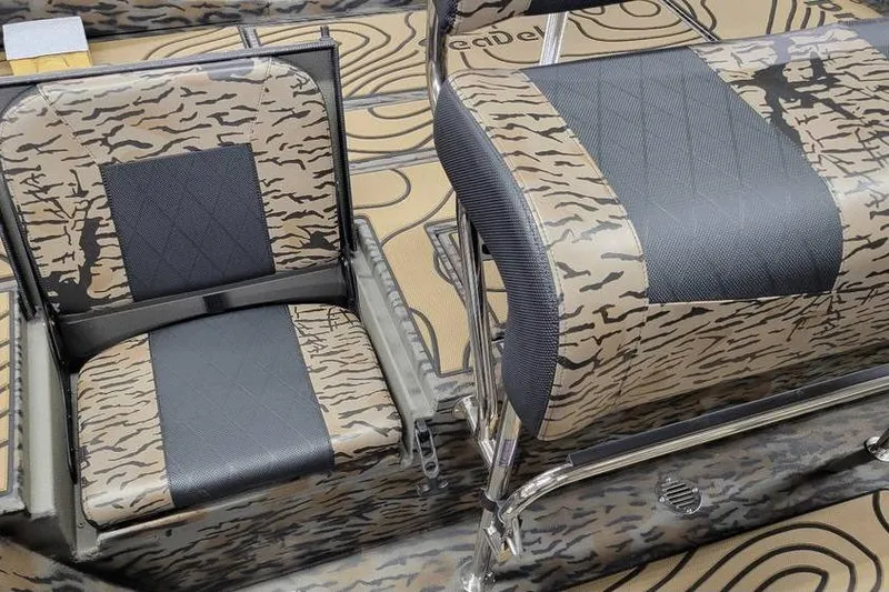 Slide: The Image of 2026 Xpress H20B Bay boat interior with camouflage design and storage compartments. - 17