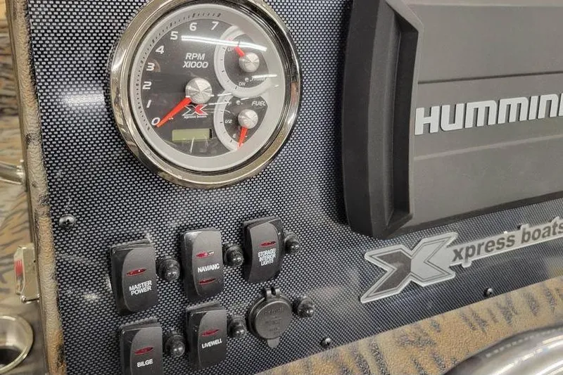 Slide: The Image of 2026 Xpress H20B Bay boat dashboard with steering wheel and control panel. - 19