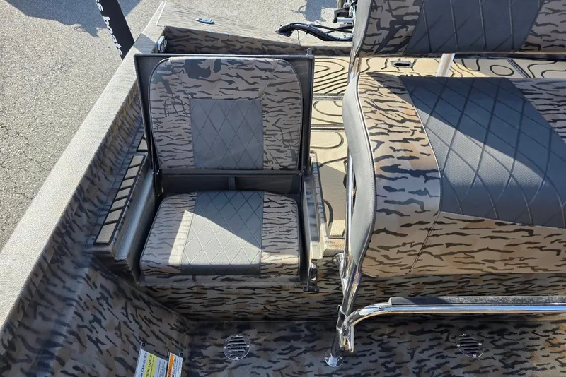 Slide: The Image of 2026 Xpress H20B Bay boat interior with camo-patterned seating and diamond stitching. - 22