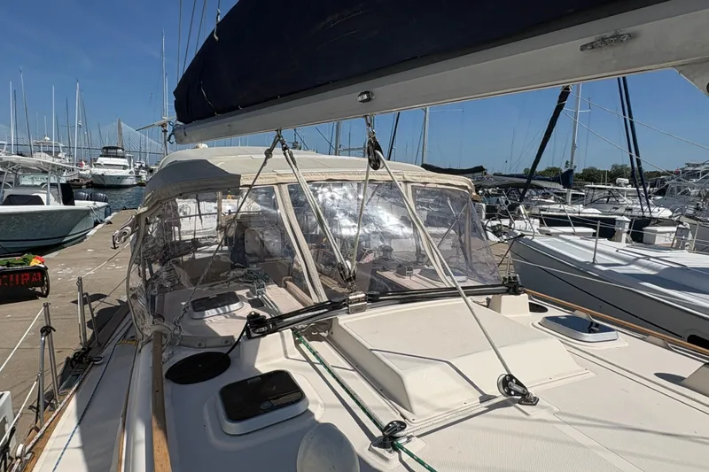 Slide: The Image of 1995 Island Packet 40 sailboat docked at a marina under clear blue skies. - 12
