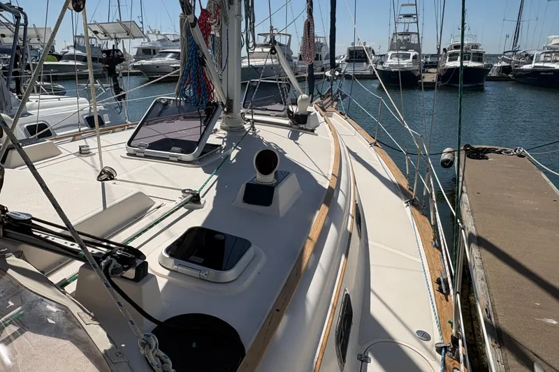 Slide: The Image of 1995 Island Packet 40 sailboat docked at marina, showcasing deck and rigging. - 14