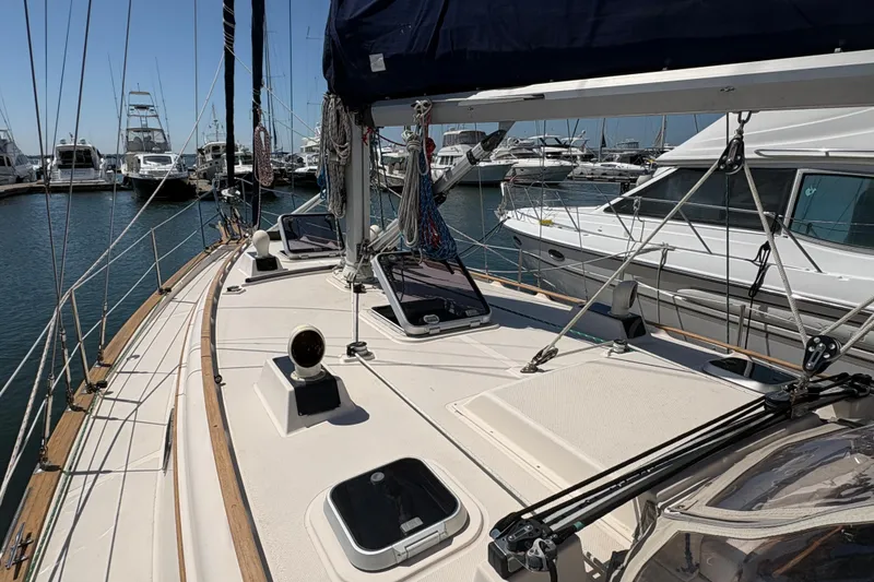 Slide: The Image of 1995 Island Packet 40 sailboat docked at marina, showcasing deck and rigging. - 15