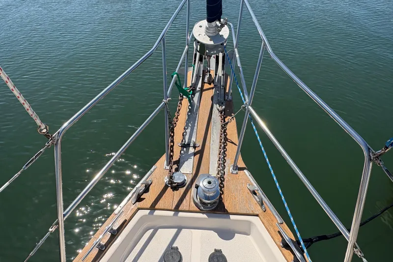 Slide: The Image of Bow of a 1995 Island Packet 40 sailboat on calm water. - 17