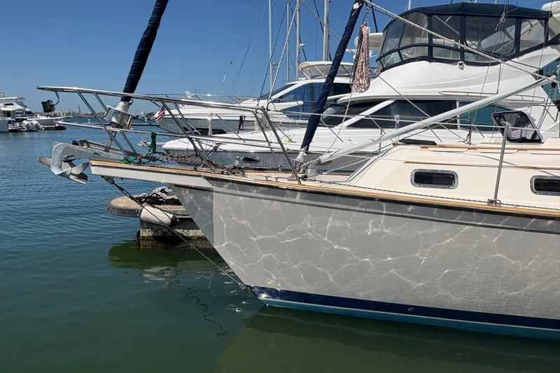 Slide: The Image of 1995 Island Packet 40 sailboat docked in a marina, surrounded by other boats. - 2