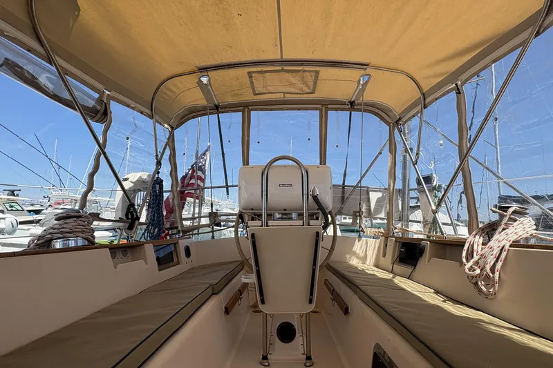 Slide: The Image of Interior view of a 1995 Island Packet 40 sailboat cockpit with seating and helm. - 20