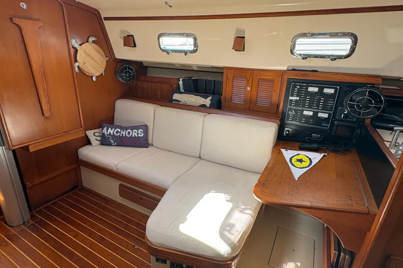 Slide: The Image of Interior of 1995 Island Packet 40 sailboat with cozy seating and navigation station. - 24