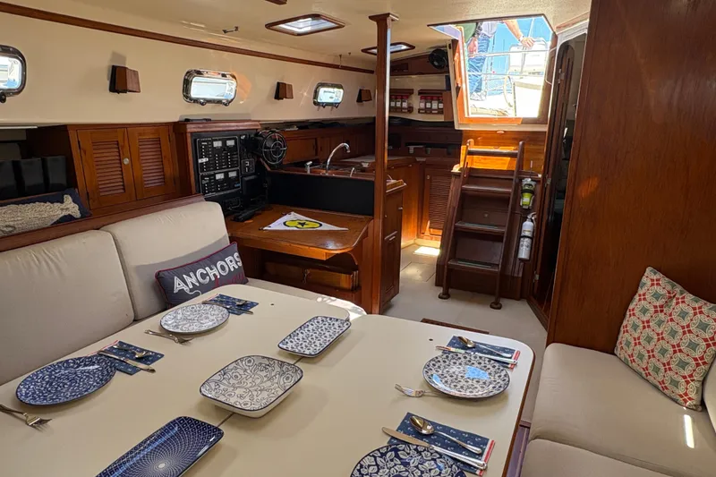 Slide: The Image of Interior of 1995 Island Packet 40 sailboat with dining area and nautical decor. - 28