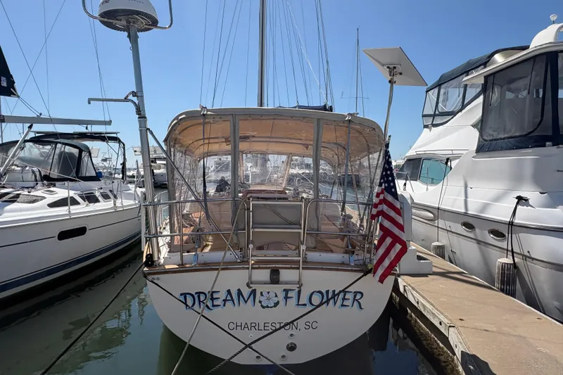 Slide: The Image of 1995 Island Packet 40 sailboat docked, named "Dream Flower," in Charleston marina. - 3