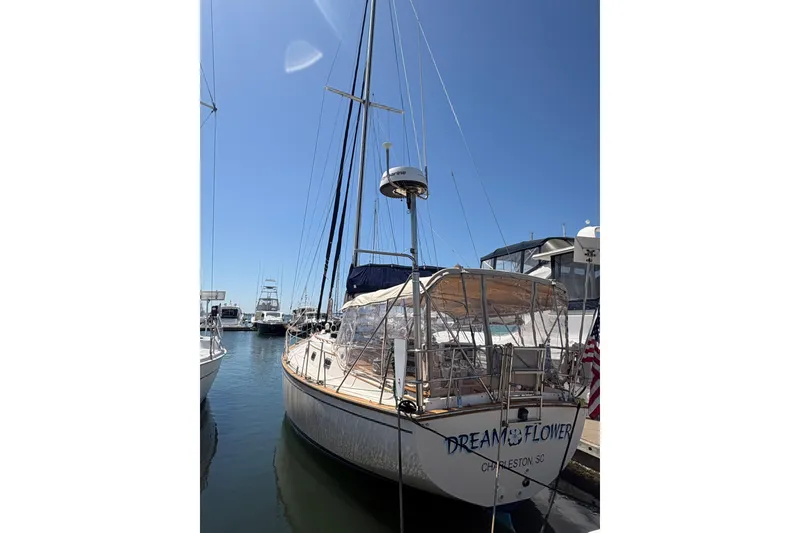 Slide: The Image of 1995 Island Packet 40 sailboat docked in marina under clear blue sky. - 4