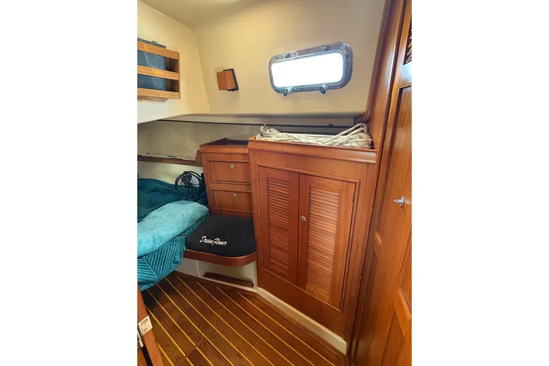 Slide: The Image of Cozy cabin interior of 1995 Island Packet 40 sailboat with wooden furnishings. - 40