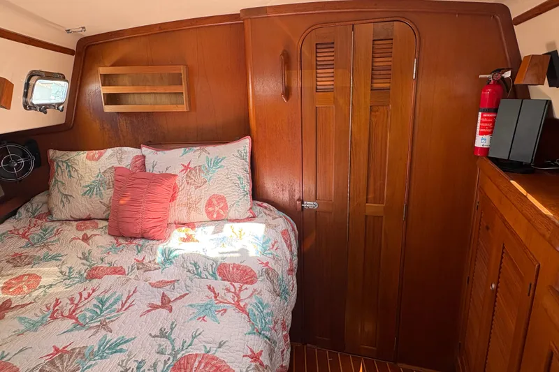 Slide: The Image of Cozy cabin interior of 1995 Island Packet 40 sailboat with nautical-themed bedding. - 47