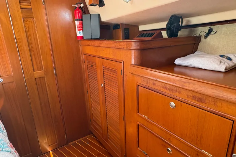 Slide: The Image of Interior of 1995 Island Packet 40 sailboat with wooden cabinetry and storage. - 48