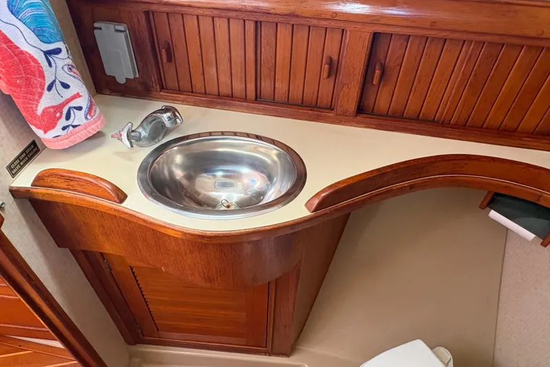 Slide: The Image of Wooden vanity with stainless steel sink in 1995 Island Packet 40 yacht bathroom. - 52