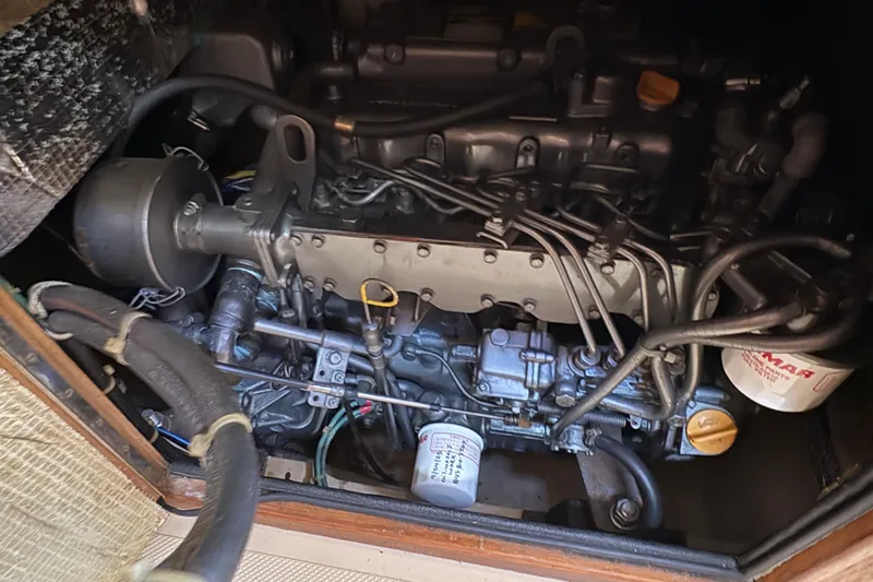 Slide: The Image of Engine compartment of a 1995 Island Packet 40 sailboat, showcasing mechanical components. - 57