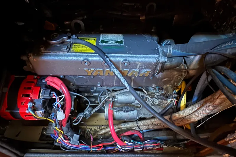 Slide: The Image of Engine compartment of a 1995 Island Packet 40 sailboat, featuring a Yanmar engine. - 58