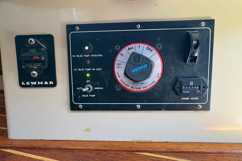 Slide: The Image of Control panel of a 1995 Island Packet 40 sailboat with bilge pump and engine hour meter. - 63