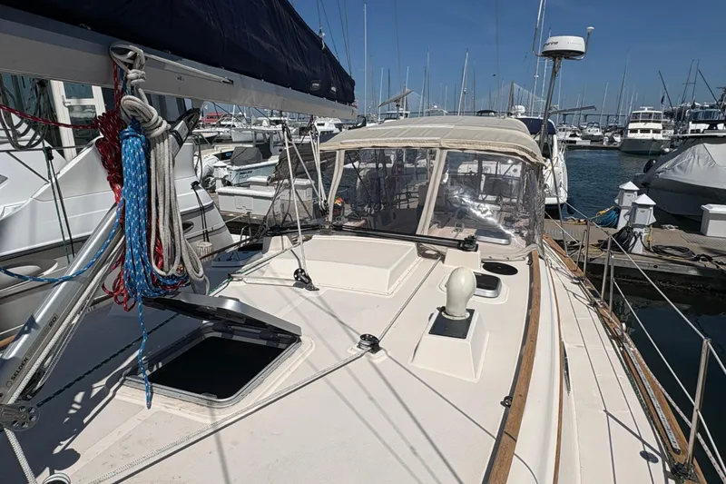 Slide: The Image of 1995 Island Packet 40 sailboat docked at marina, featuring deck and rigging. - 9