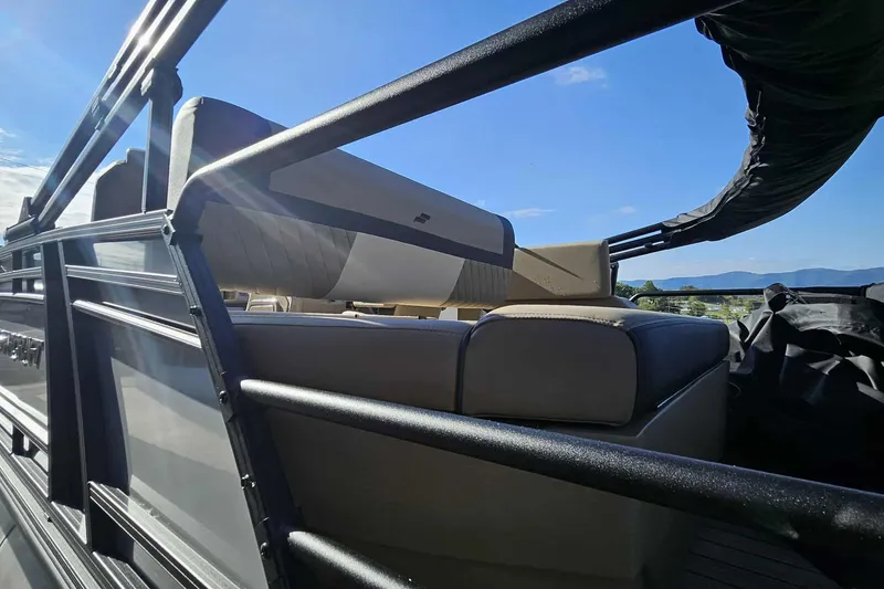 Slide: The Image of 2026 Starcraft EXS 3 Q DH boat interior with cushioned seating and scenic mountain view. - 12