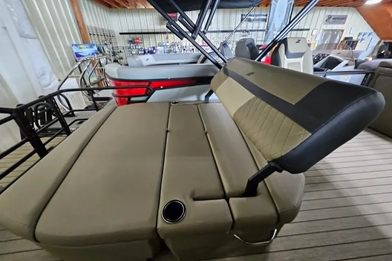 Slide: The Image of 2026 Starcraft EXS 3 Q DH boat interior with beige seating and cup holder. - 17