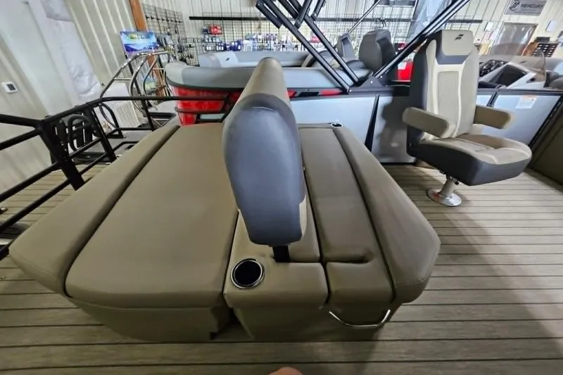 Slide: The Image of 2026 Starcraft EXS 3 Q DH boat interior with beige seating and cup holder. - 18
