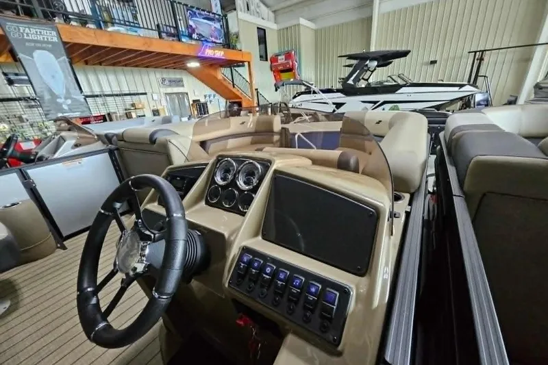 Slide: The Image of Interior view of 2026 Starcraft EXS 3 Q DH boat, showcasing steering wheel and dashboard controls. - 20