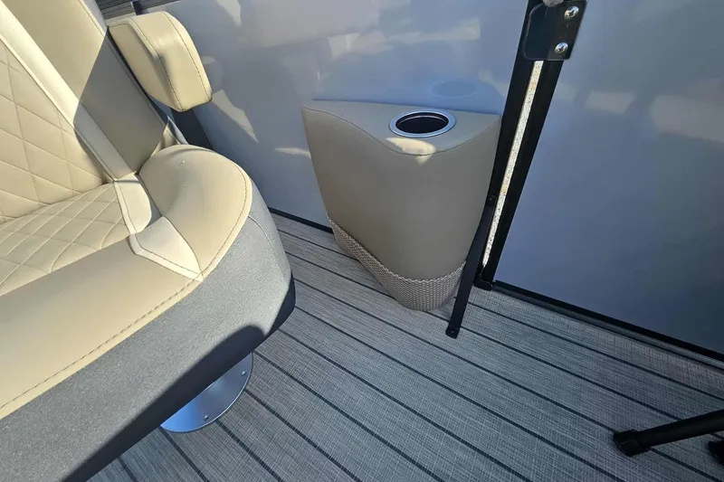 Slide: The Image of Luxurious interior of 2026 Starcraft EXS 3 Q DH boat with beige seating and cup holder. - 5