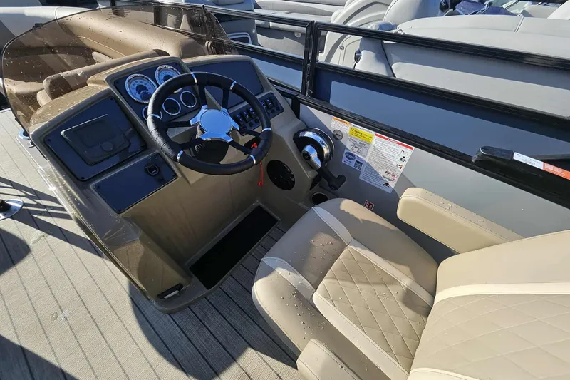 Slide: The Image of 2026 Starcraft EXS 3 Q DH boat dashboard with steering wheel and beige seating. - 8