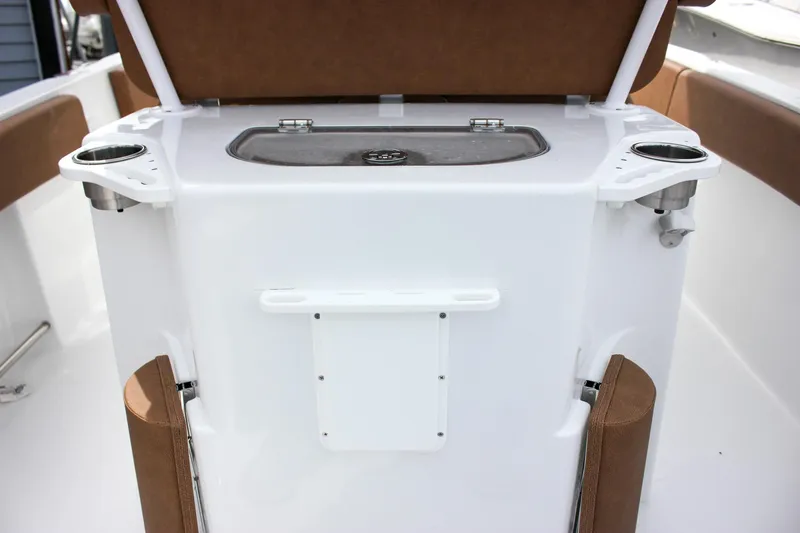 Slide: The Image of 2026 Sea Hunt Ultra 235 SE boat console with cup holders and storage. - 13