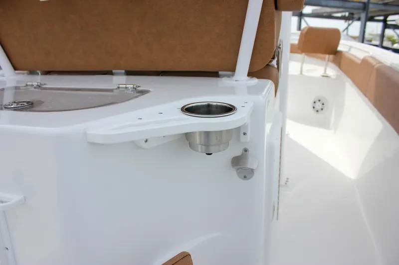 Slide: The Image of 2026 Sea Hunt Ultra 235 SE boat interior with cup holder and seating. - 14