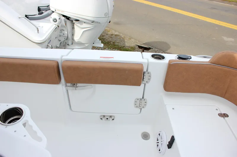 Slide: The Image of 2026 Sea Hunt Ultra 235 SE boat interior with tan seating and white deck. - 15