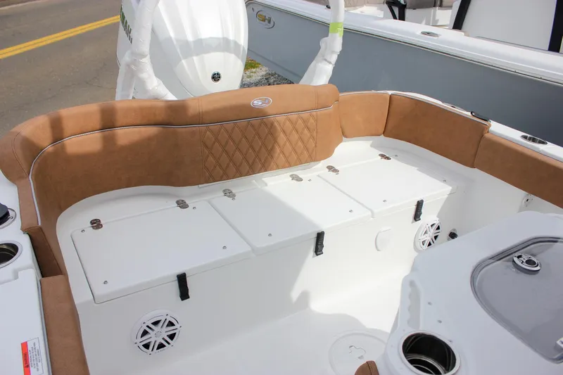 Slide: The Image of 2026 Sea Hunt Ultra 235 SE boat interior with tan seating and storage compartments. - 16