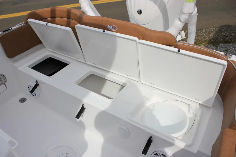 Slide: The Image of 2026 Sea Hunt Ultra 235 SE boat storage compartments and seating area. - 18