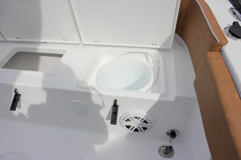 Slide: The Image of 2026 Sea Hunt Ultra 235 SE boat interior with storage compartments and speaker. - 19