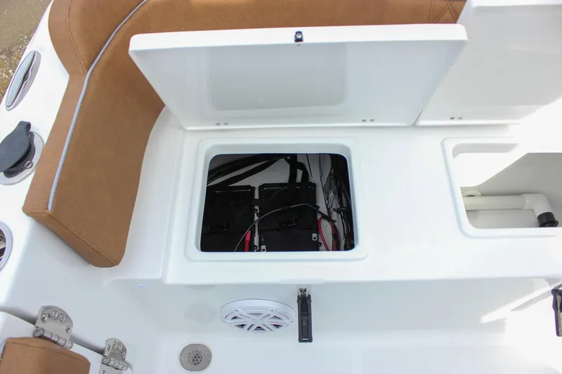 Slide: The Image of 2026 Sea Hunt Ultra 235 SE boat storage compartment with open hatch and visible wiring. - 21