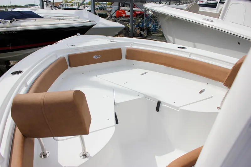 Slide: The Image of 2026 Sea Hunt Ultra 235 SE boat interior with tan seating and white deck. - 28