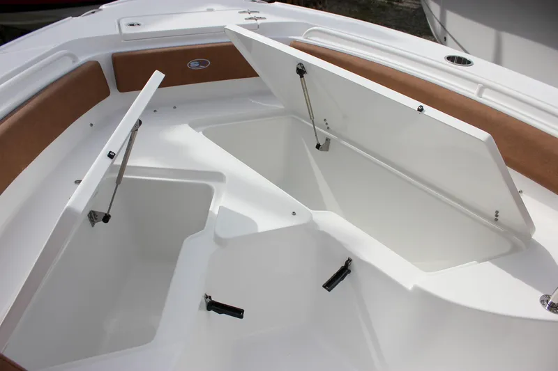 Slide: The Image of 2026 Sea Hunt Ultra 235 SE boat storage compartments with open hatches, showcasing spacious design. - 29