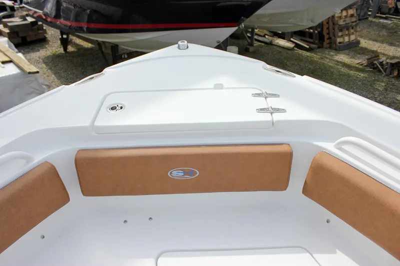 Slide: The Image of 2026 Sea Hunt Ultra 235 SE boat interior with cushioned seating and storage compartment. - 30