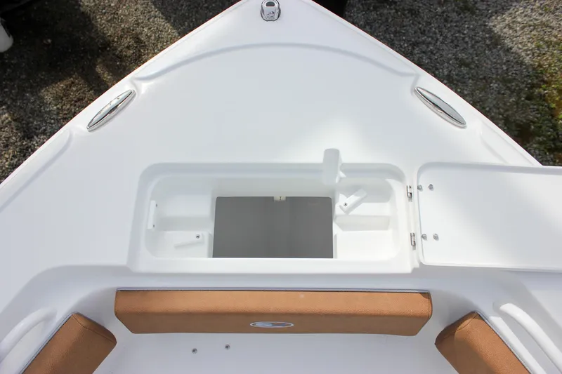 Slide: The Image of 2026 Sea Hunt Ultra 235 SE boat bow storage compartment with cushioned seating. - 31