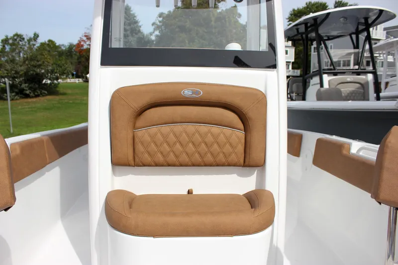 Slide: The Image of 2026 Sea Hunt Ultra 235 SE boat interior with tan cushioned seating. - 35