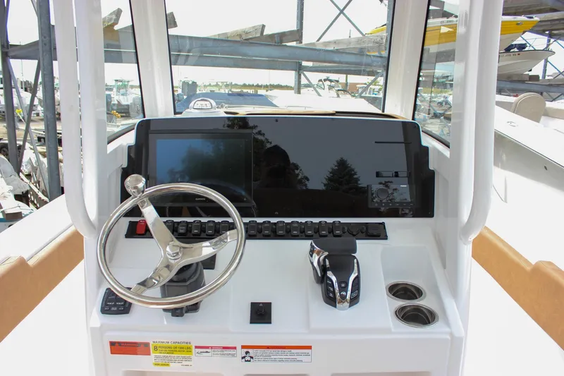 Slide: The Image of Helm of 2026 Sea Hunt Ultra 235 SE with steering wheel and control panel. - 38