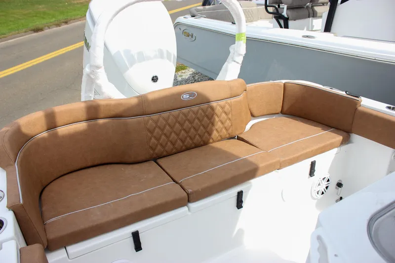 Slide: The Image of 2026 Sea Hunt Ultra 235 SE boat with brown cushioned seating and white interior. - 39