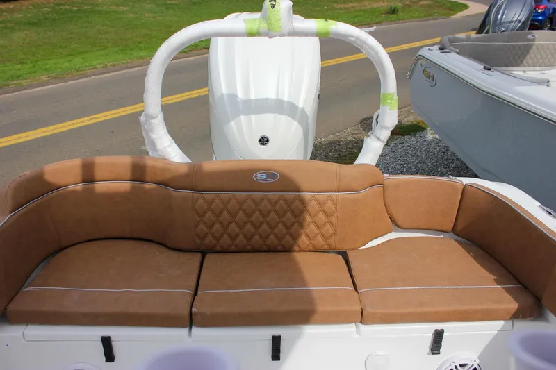 Slide: The Image of 2026 Sea Hunt Ultra 235 SE boat with tan cushioned seating and wrapped components. - 40