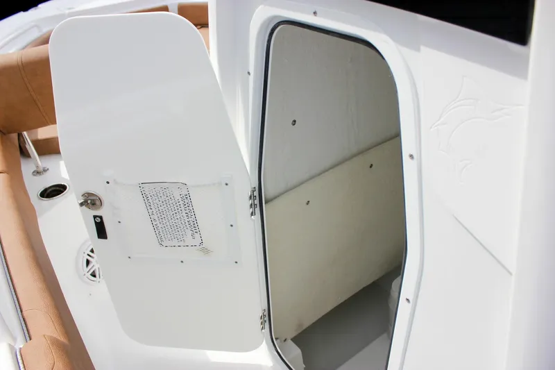 Slide: The Image of 2026 Sea Hunt Ultra 235 SE boat cabin entrance with open door. - 47