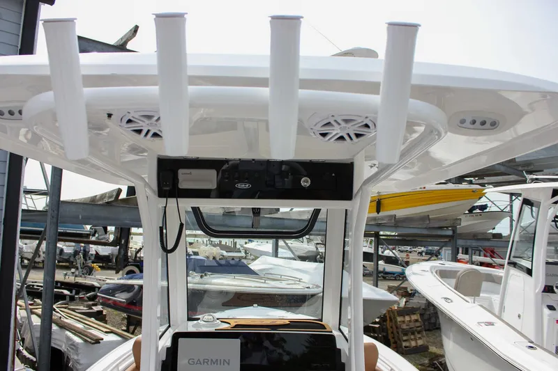 Slide: The Image of 2026 Sea Hunt Ultra 235 SE boat console with rod holders and Garmin electronics. - 49