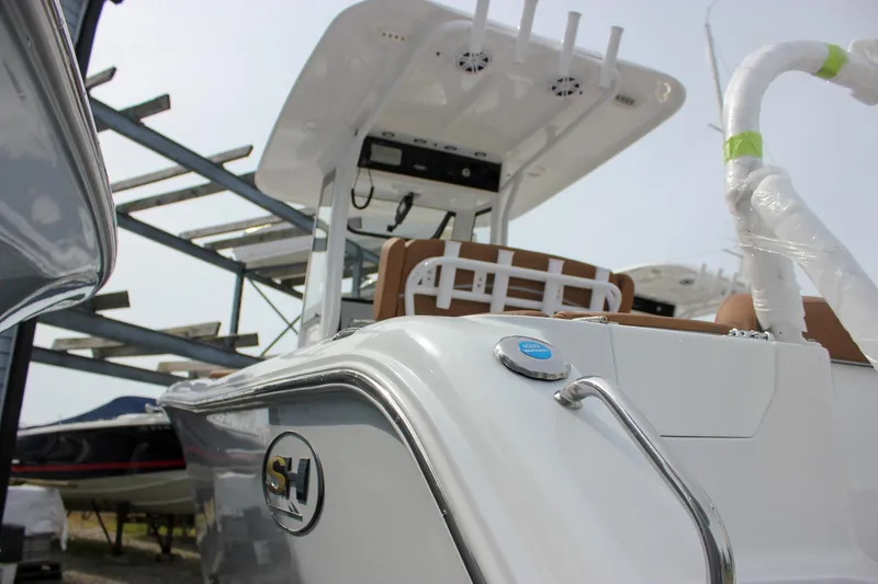 Slide: The Image of 2026 Sea Hunt Ultra 235 SE boat in storage, showcasing sleek design and modern features. - 5