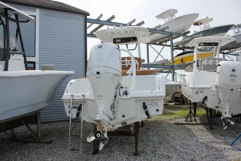 Slide: The Image of 2026 Sea Hunt Ultra 235 SE boat with powerful outboard motor in storage. - 50