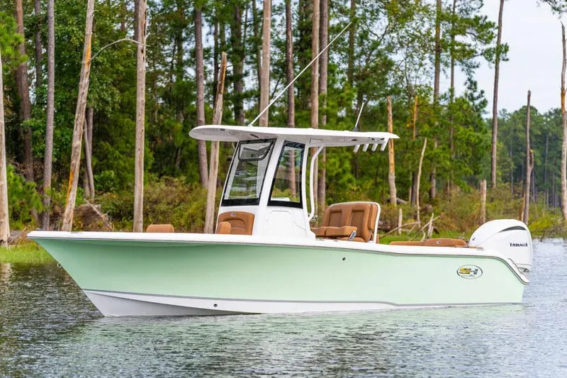 Slide: The Image of Manufacturer Provided Image: 2026 Sea Hunt Ultra 235 SE boat on calm water, surrounded by trees. - 53