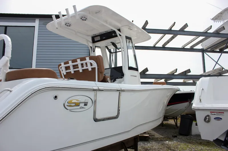 Slide: The Image of 2026 Sea Hunt Ultra 235 SE boat with sleek design in a storage area. - 6