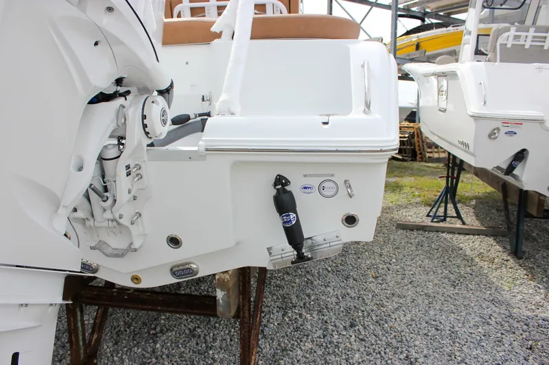 Slide: The Image of 2026 Sea Hunt Ultra 235 SE boat rear view with motor and dock fender. - 7